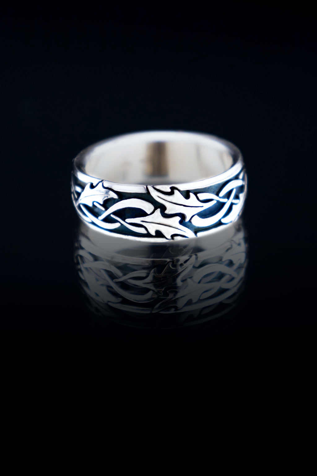 Holly leaf Celtic wedding band in sterling silver, oxidized texture with detailed leaf pattern