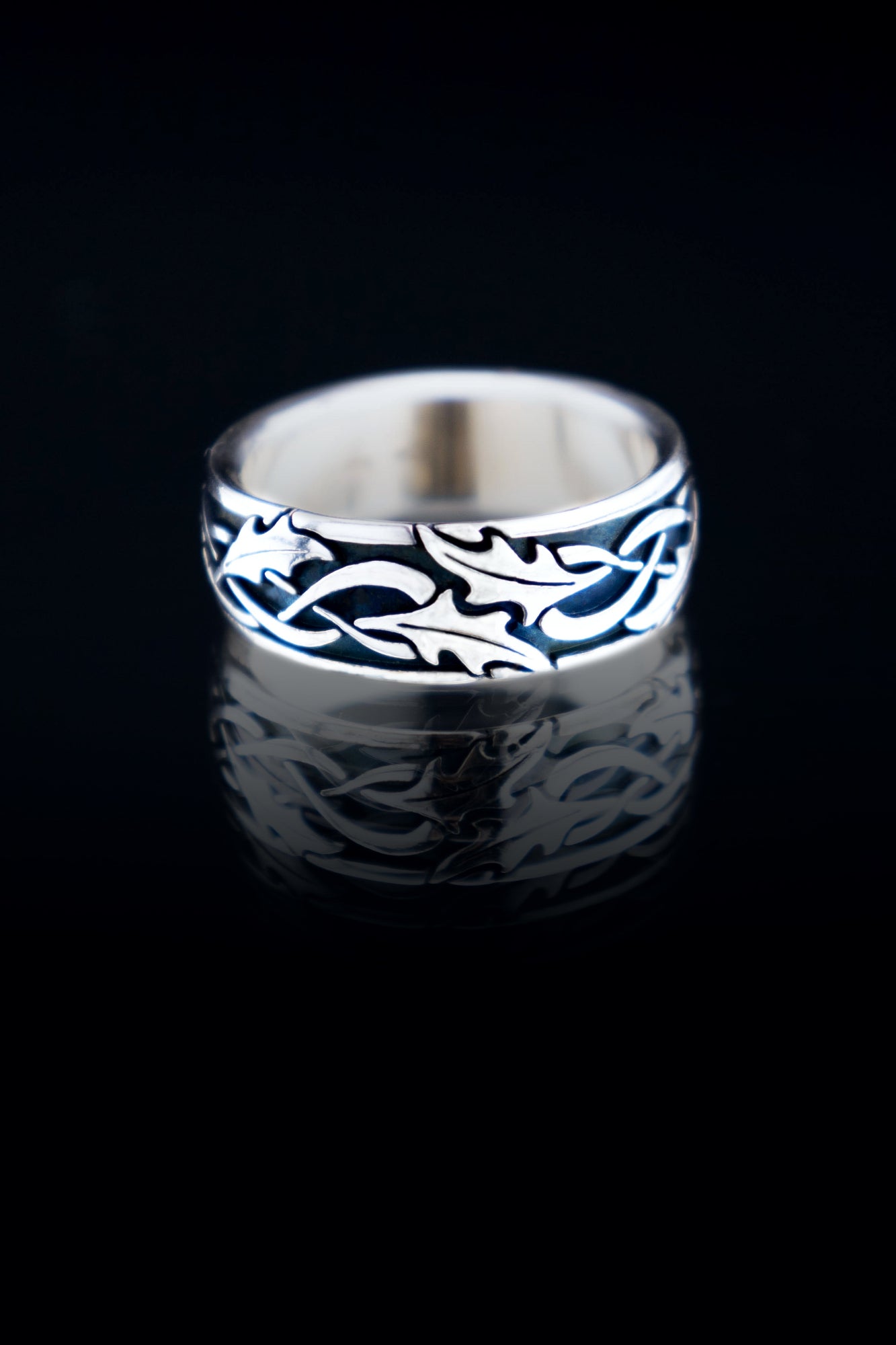 Holly leaf Celtic wedding band in sterling silver, oxidized texture with detailed leaf pattern