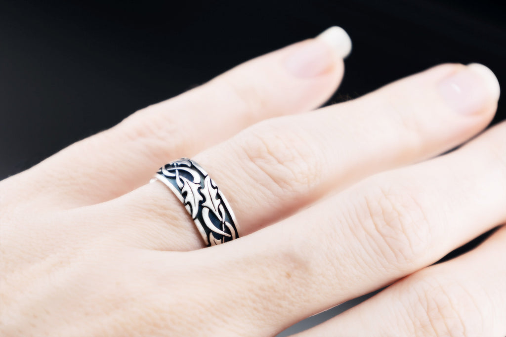 Holly leaf Celtic ring worn on hand, sterling silver oxidized wedding band