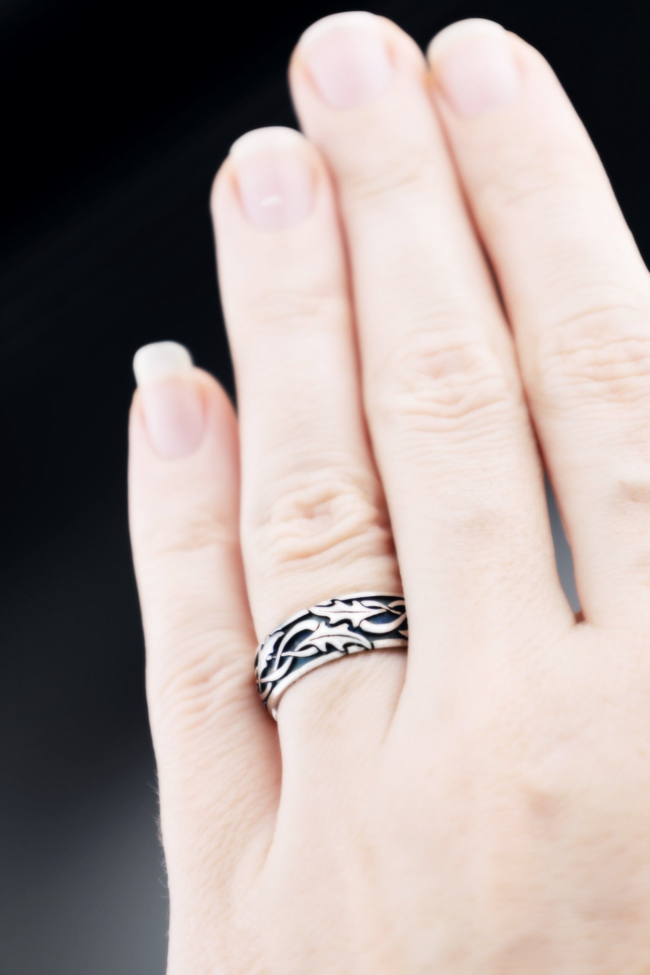 Holly leaf Celtic ring worn on hand, sterling silver oxidized wedding band