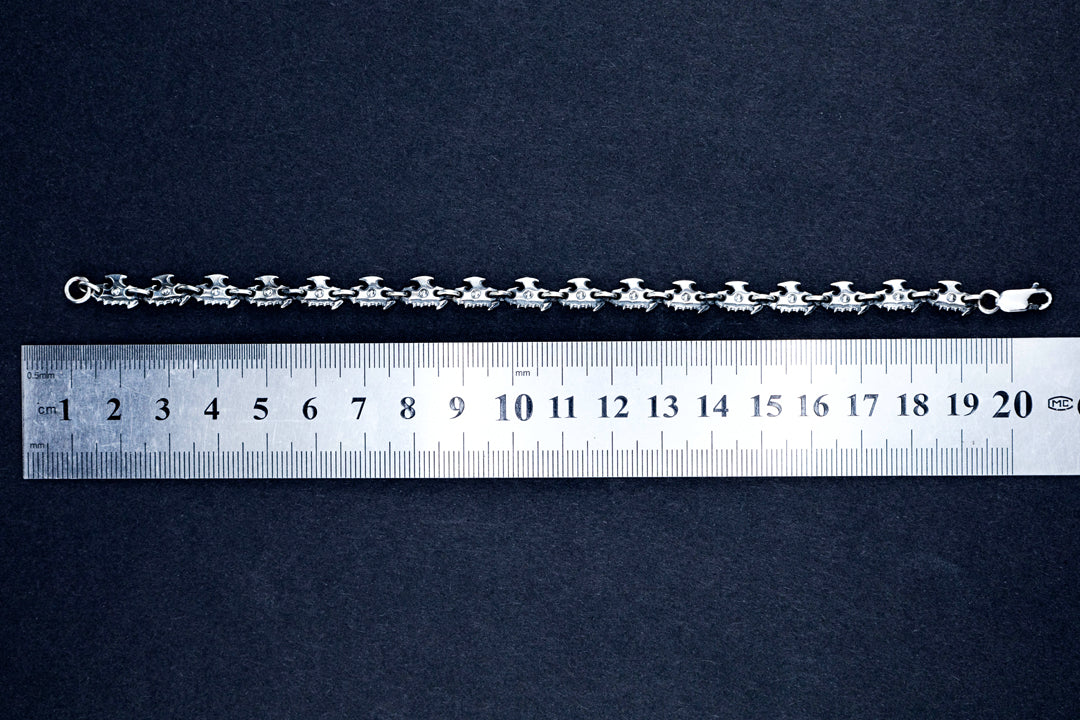 Oxidized silver chain bracelet laid flat next to ruler, showing 19 cm length