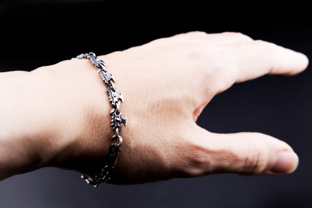 Oxidized silver chainsaw chain bracelet worn on wrist, dark fantasy gothic jewelr