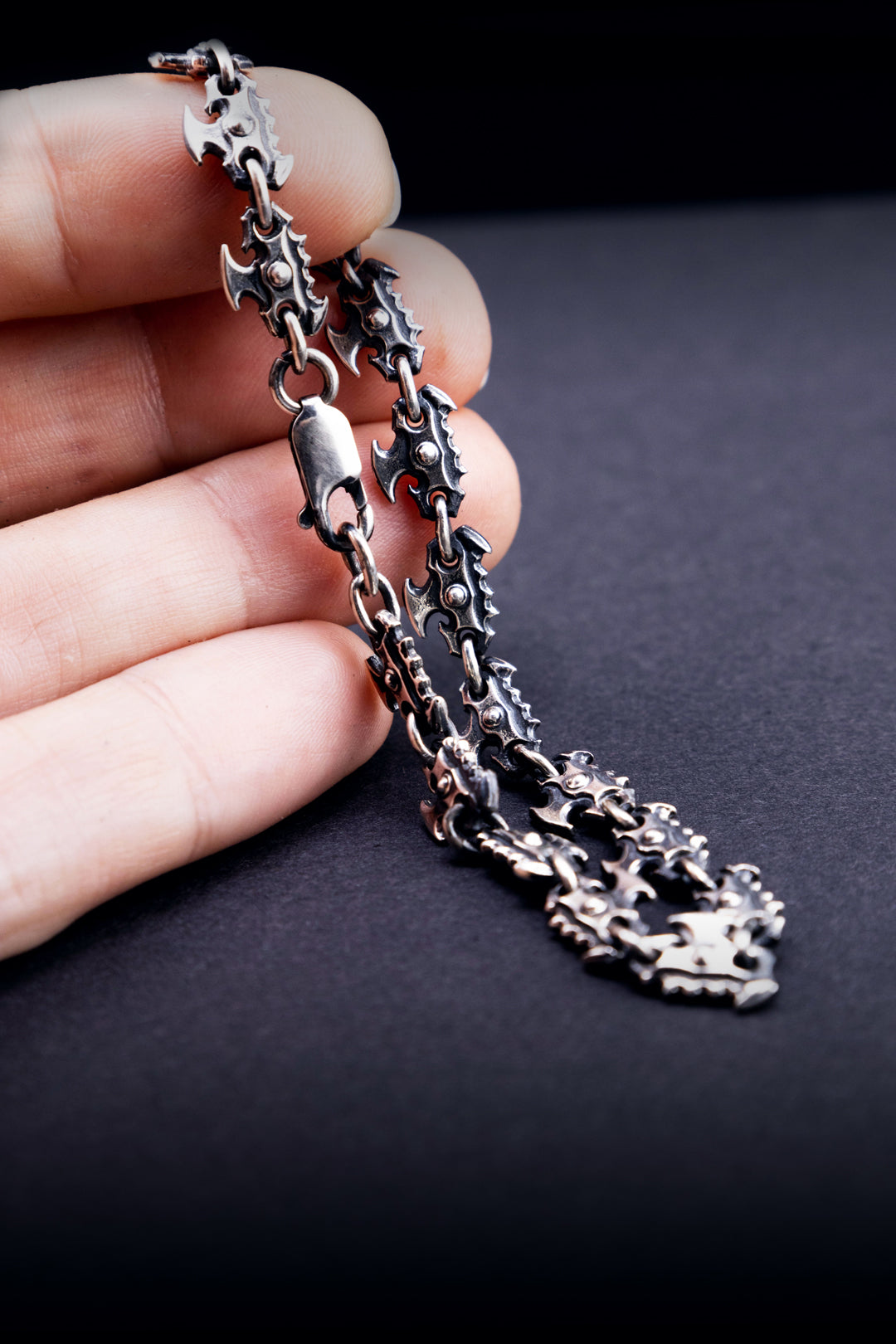 Close-up of handmade sterling silver chain bracelet clasp and sculpted link detail