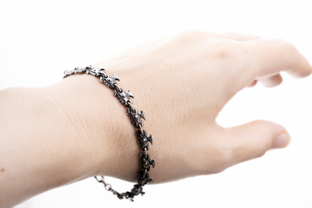 Oxidized silver chainsaw chain bracelet worn on wrist, dark fantasy gothic jewelry