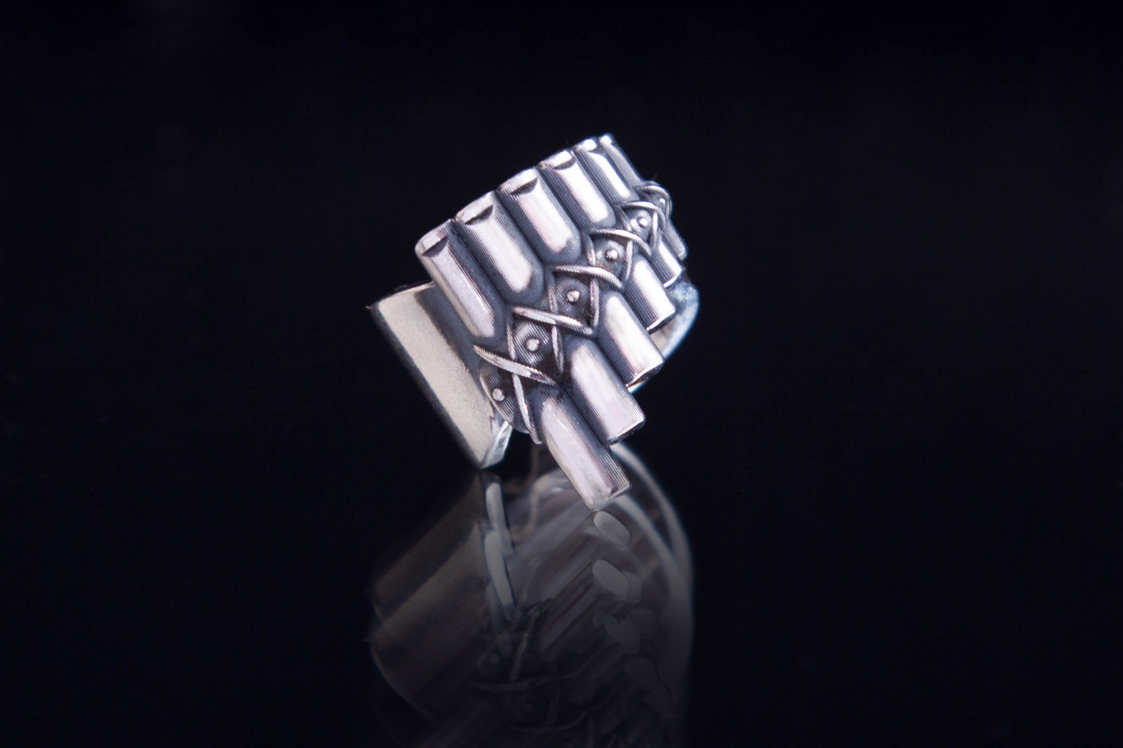 Sculptural silver ear cuff inspired by ancient music and folk instruments