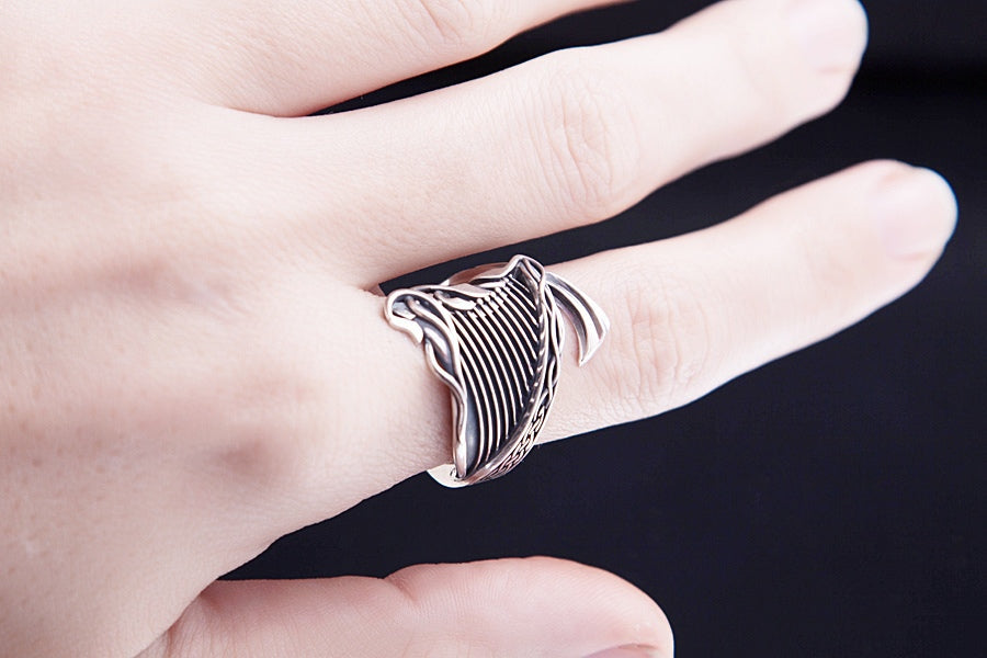 Sterling silver Celtic harp statement ring on hand, bold music inspired jewelry