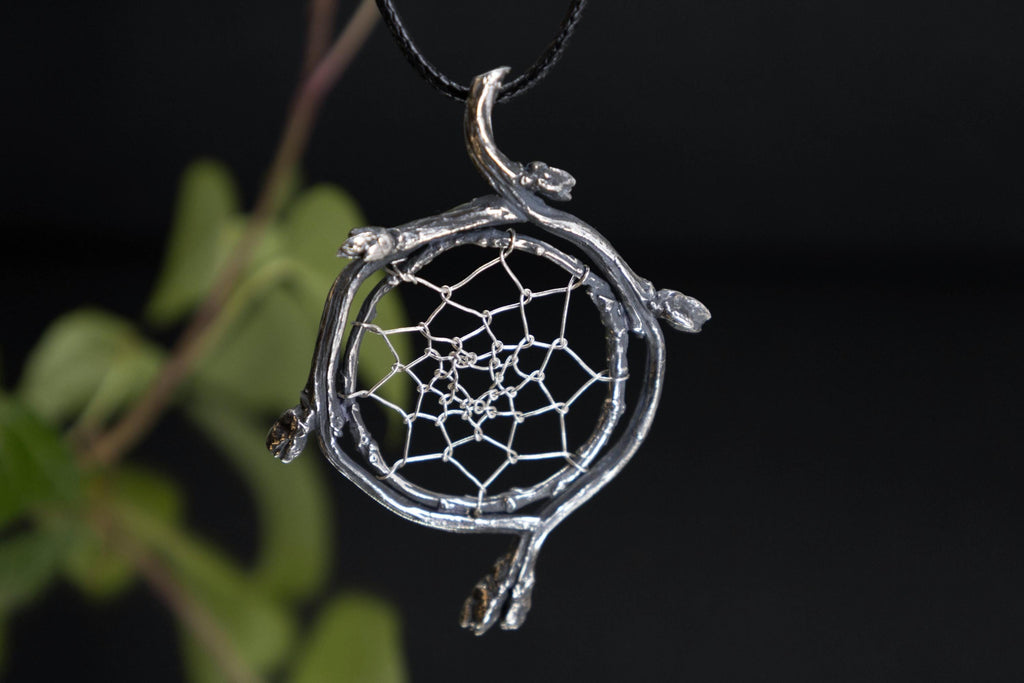 Handmade silver dreamcatcher amulet with woven web detail