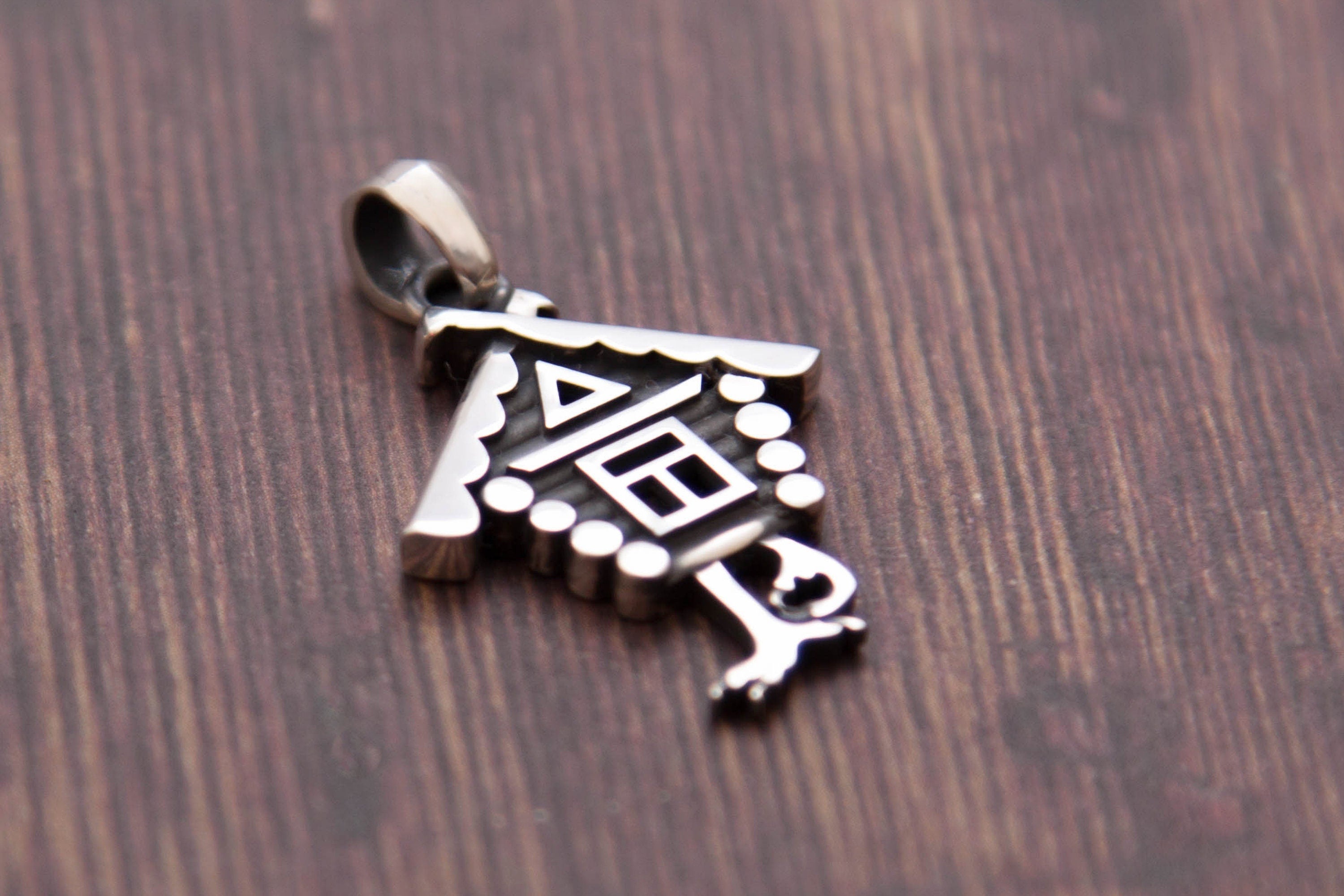 Baba Yaga house necklace styled on wood background