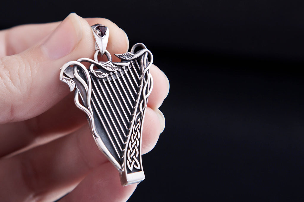 Handcrafted silver harp charm with garnet