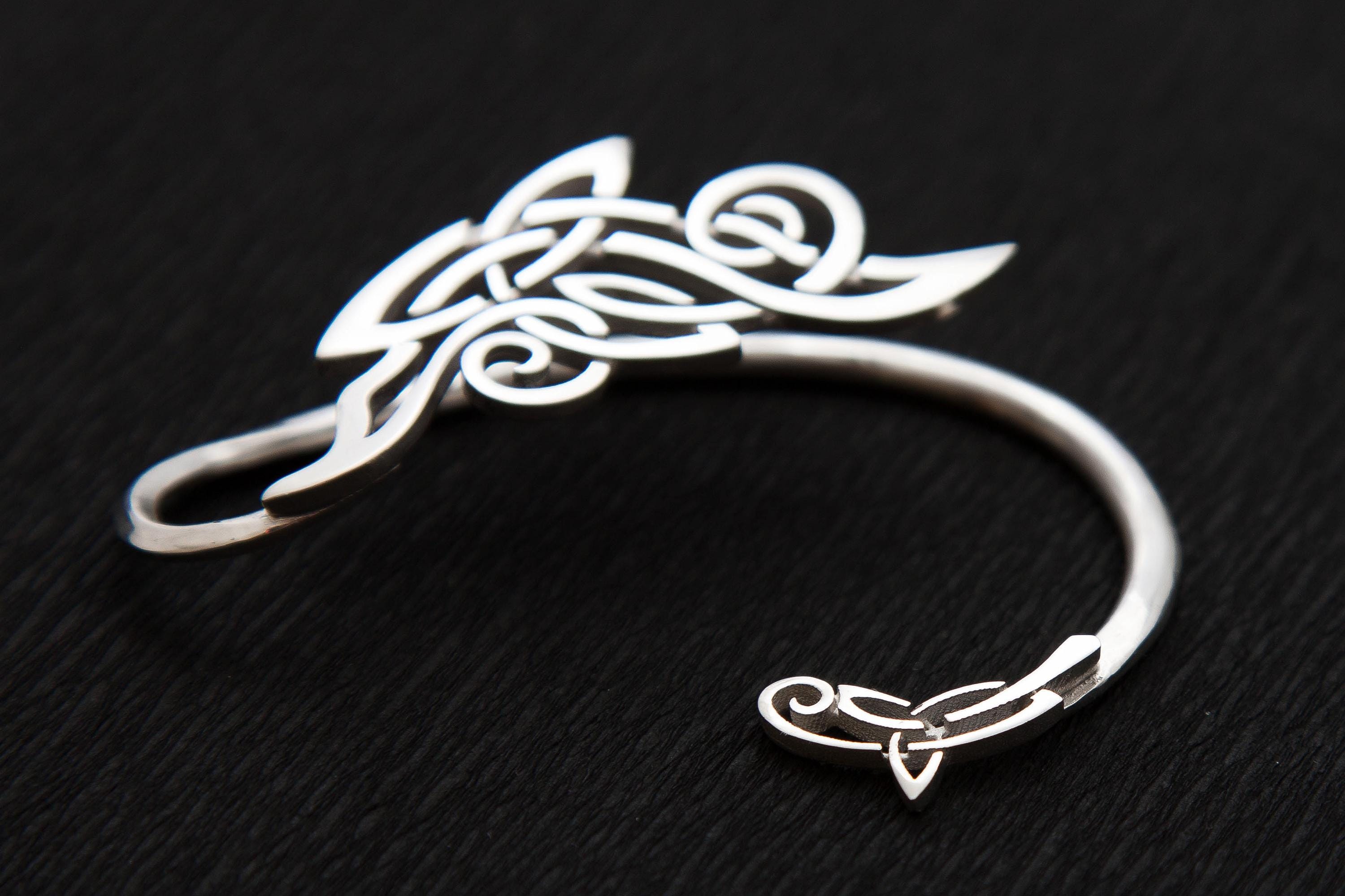 Close-up of handcrafted silver ear wrap, Celtic and winter frosts pattern style