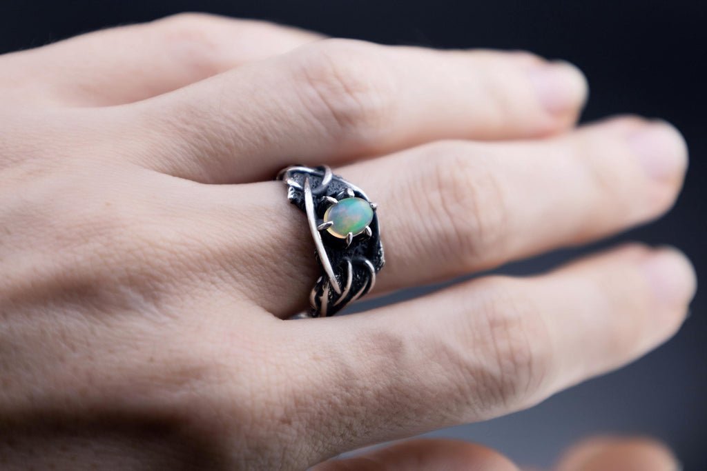 Ethiopian opal silver ring worn on hand
