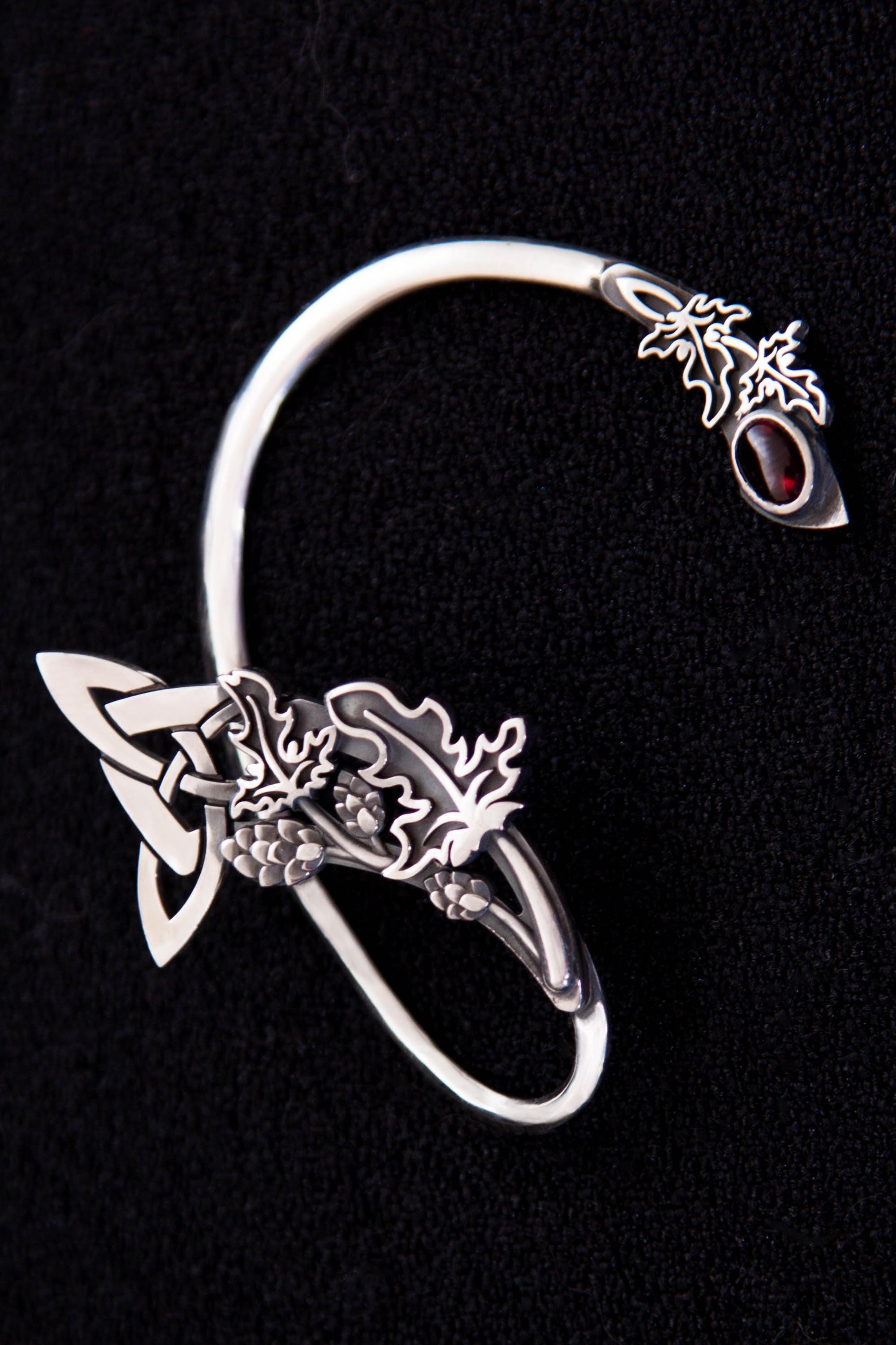 Side view of Celtic ear cuff with hop cones and garnet