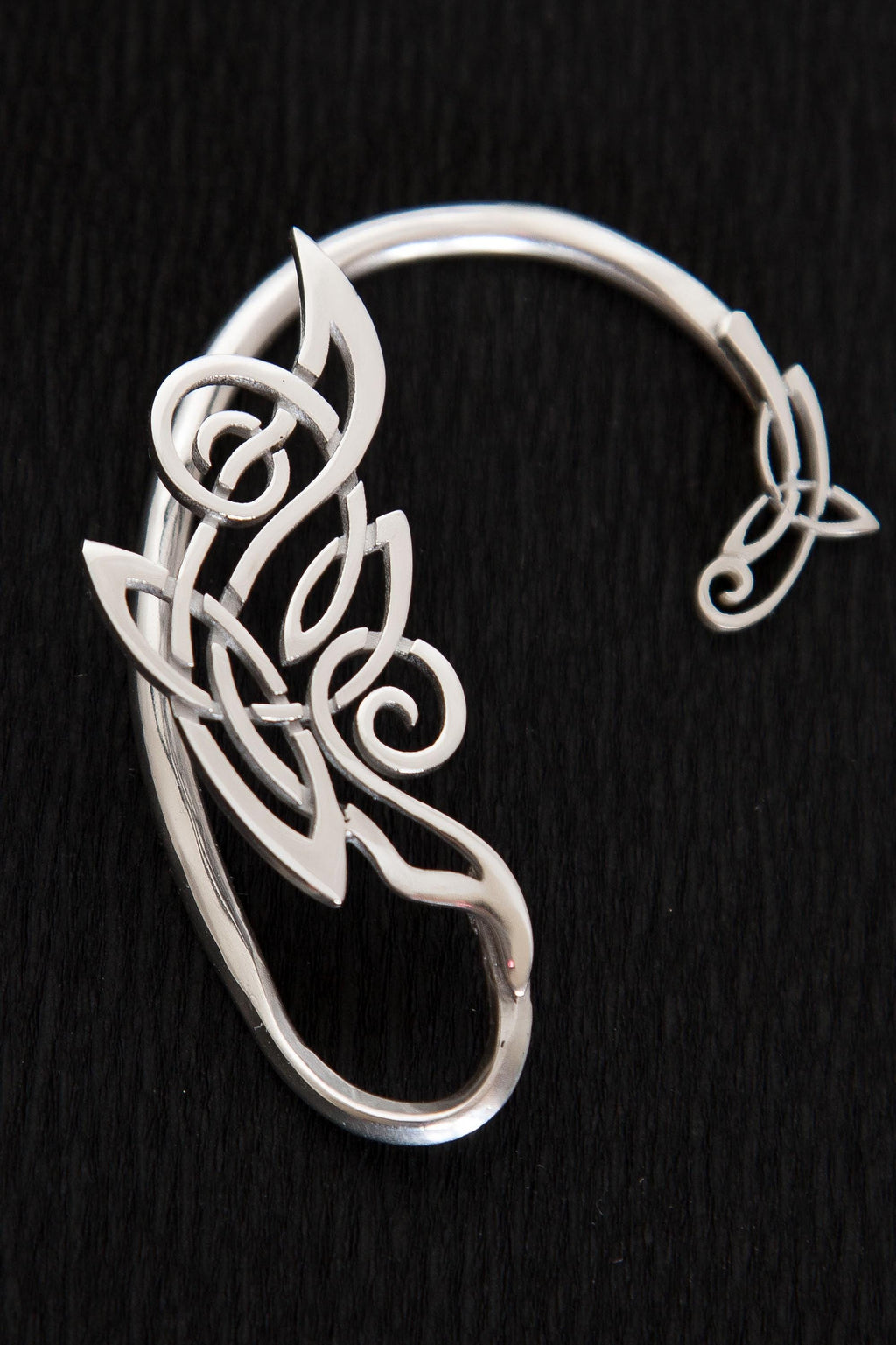Close-up of handcrafted silver Celtic ear wrap