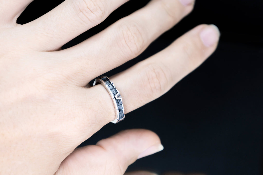 Unisex silver portal glyph band worn on hand