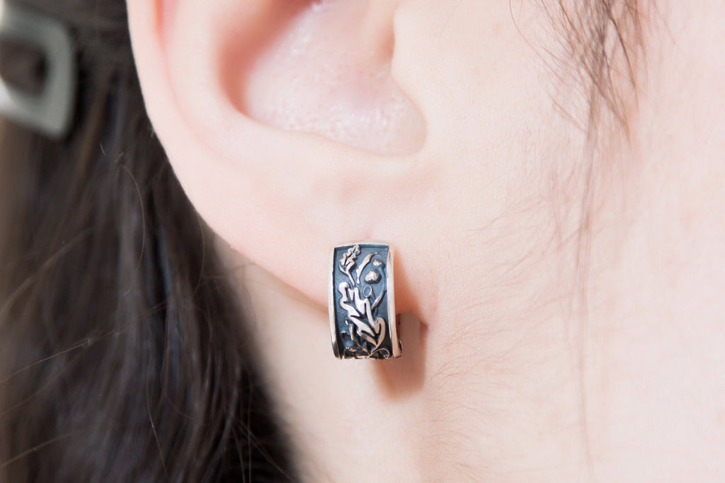 Elven forest inspired silver earrings worn on ear