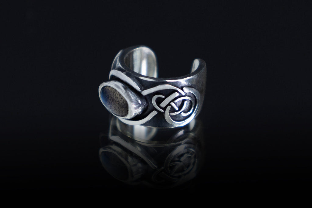 Artisan silver elven ear cuff with gemstone on dark background