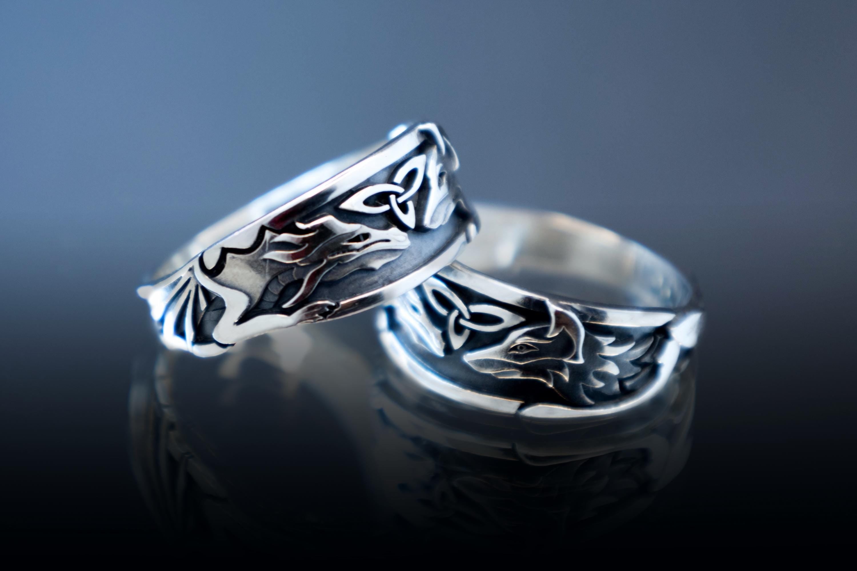Silver ring with dragon and fox intertwined design