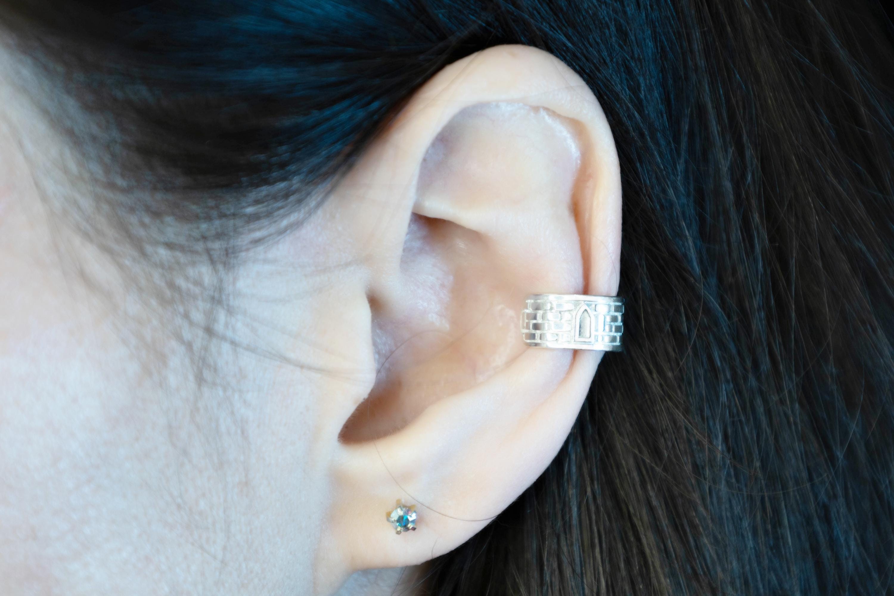 No piercing silver ear cuff worn on ear