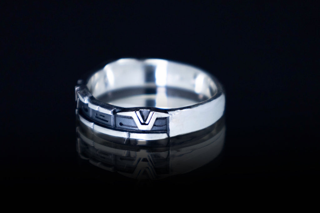 Close-up of engraved sci-fi rune ring in silver