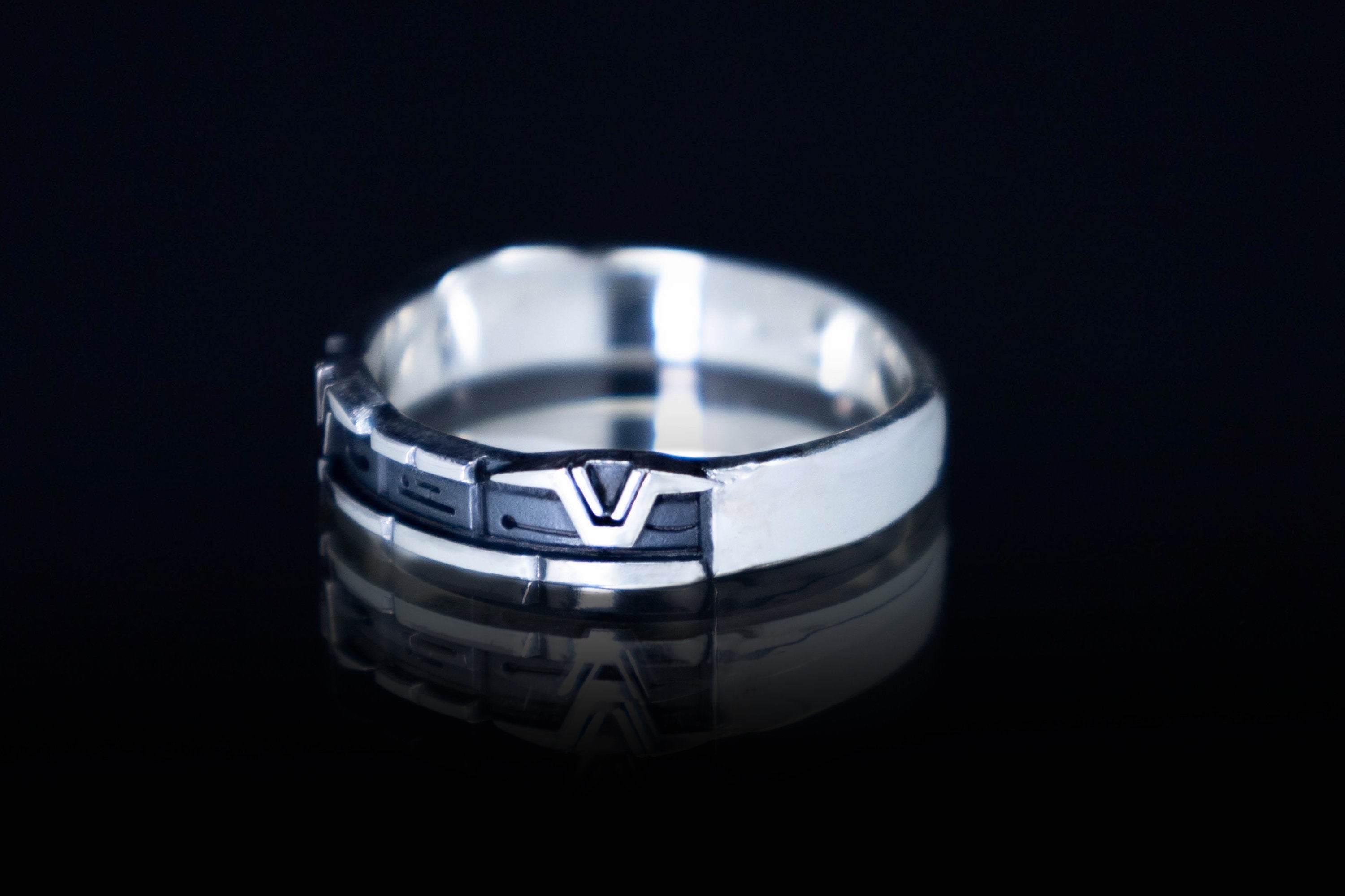 Close-up of engraved sci-fi rune ring in silver