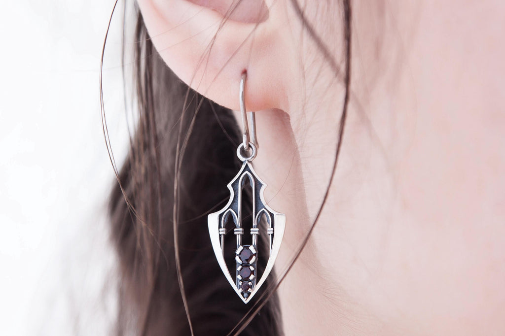 Gothic fantasy silver earrings modeled on ear, elongated shield form