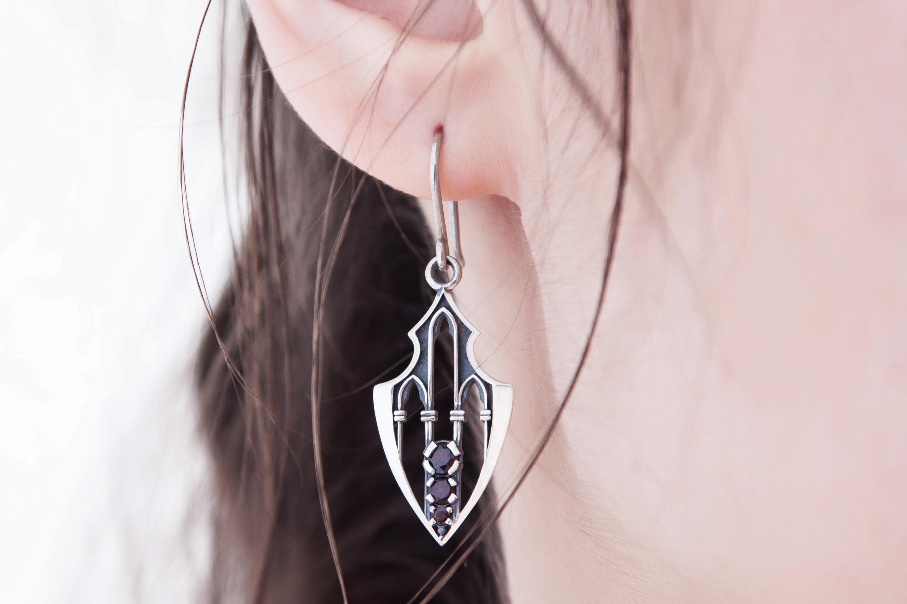 Gothic fantasy silver earrings modeled on ear, elongated shield form