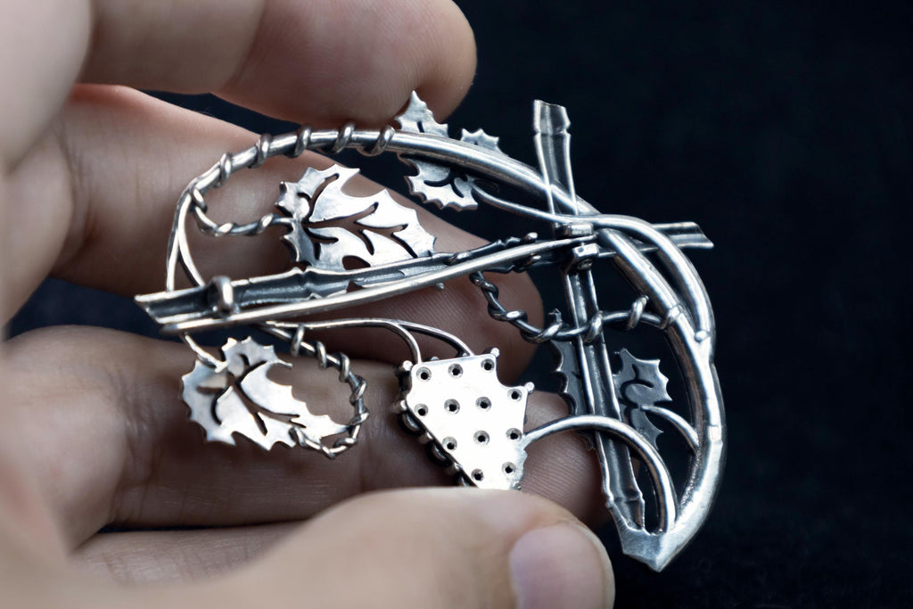 Back view of sterling silver grape leaves and garnet cluster brooch