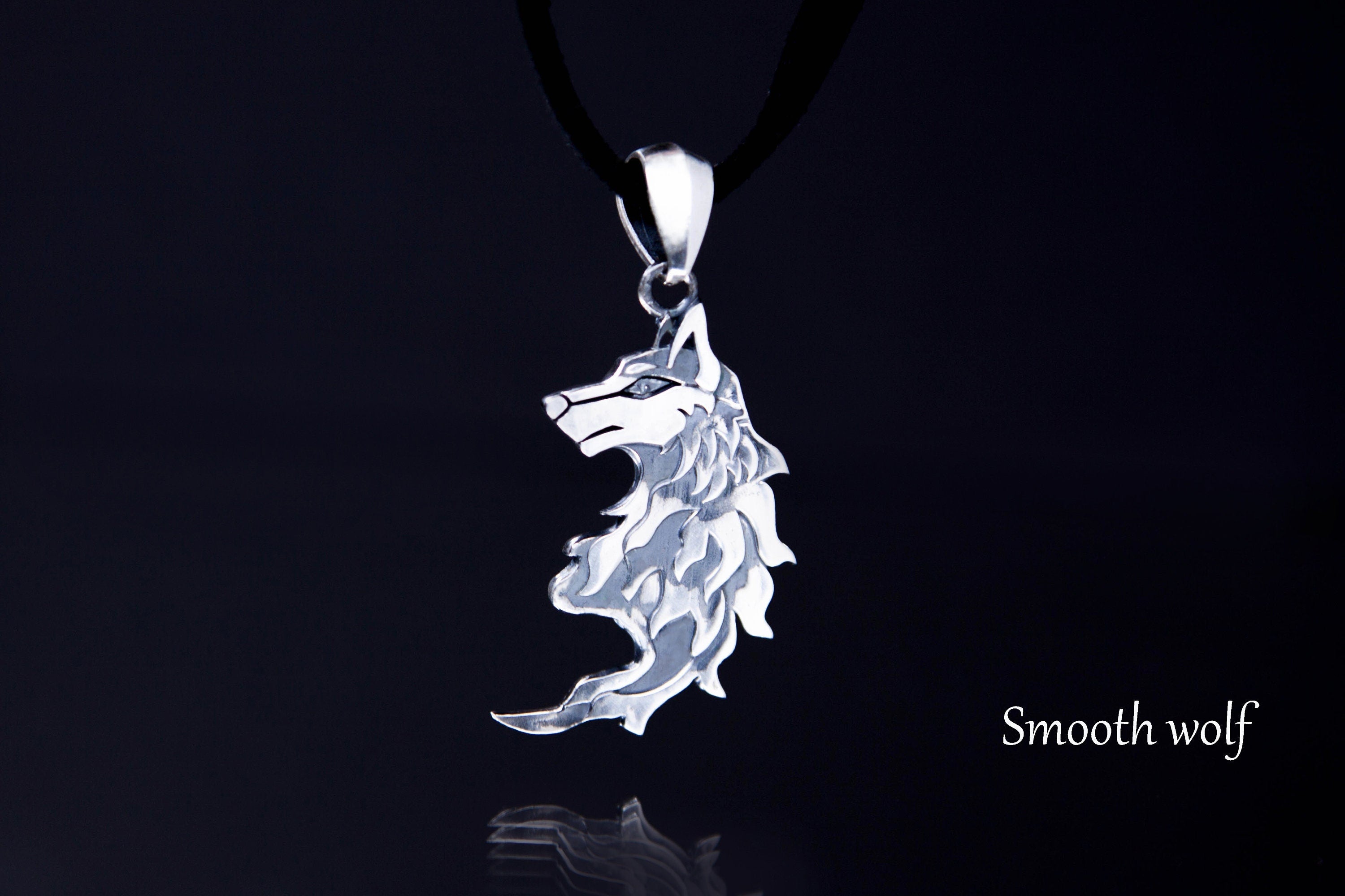 Silver wolf pendant on dark background, jewelry for couple